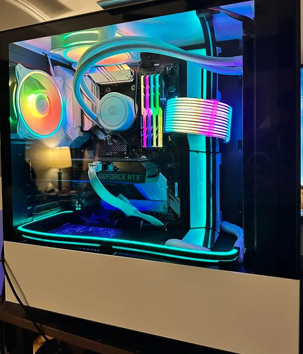 White and black desktop PC with cyan lighting and colorful illuminated cables