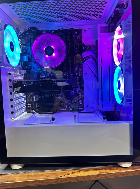 White desktop case with blue and purple fans visible through its glass panel