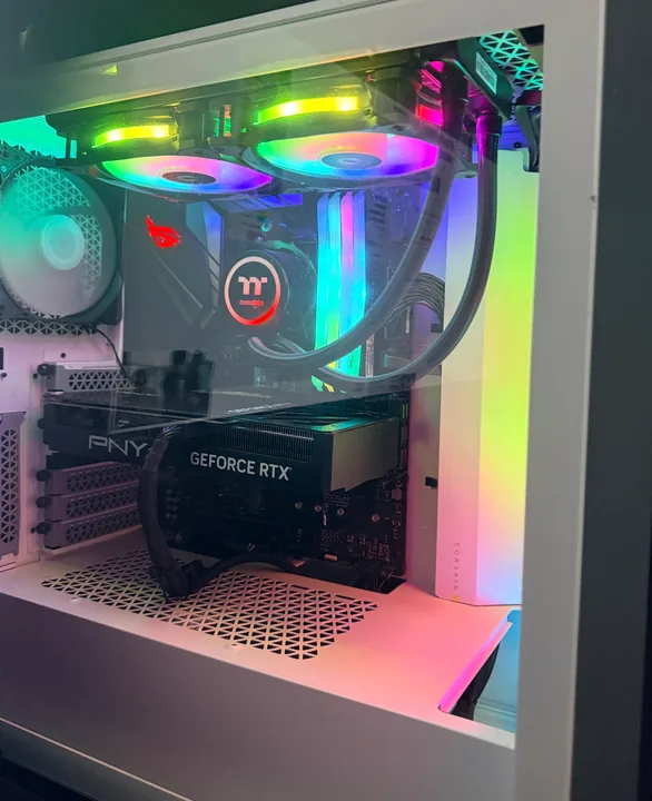 White PC case with rainbow lighting, cooling tubes and a graphics card